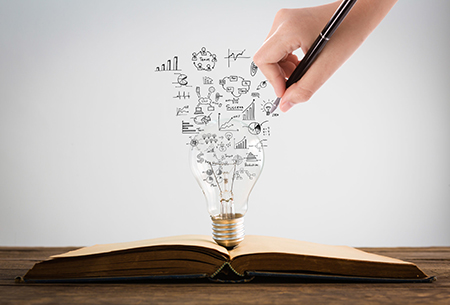 Book and light bulb with hand drawing graph